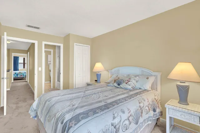 a bedroom with a bed and a lamp