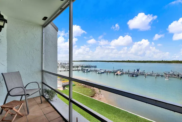 a view of swimming pool with outdoor seating and city view