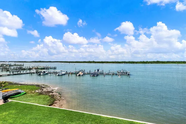 a view of a lake with houses in the back