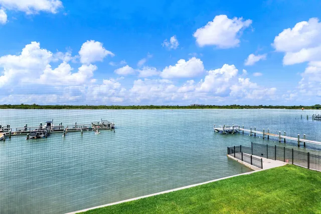 a view of a lake with houses in the back