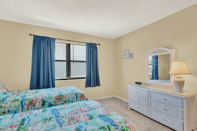 a bedroom with a bed and a dresser in it