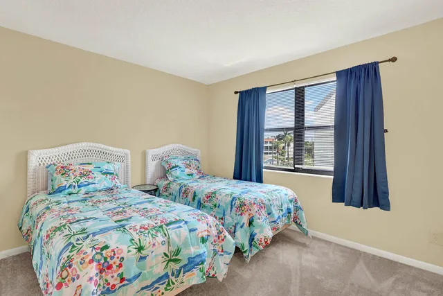 a bedroom with two beds and a window