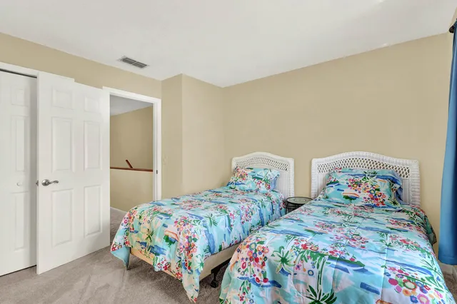 a bedroom with two beds and a lamp