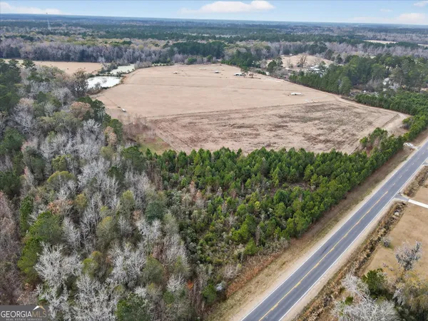 a view of a yard with wooden fence