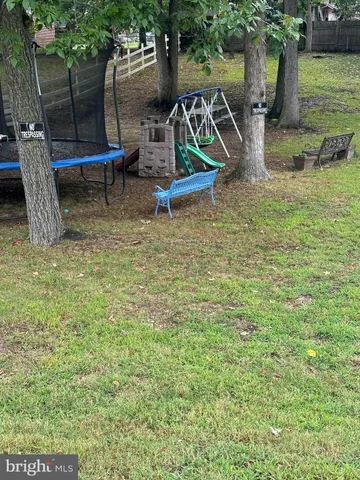 a view of a backyard with chairs and a table