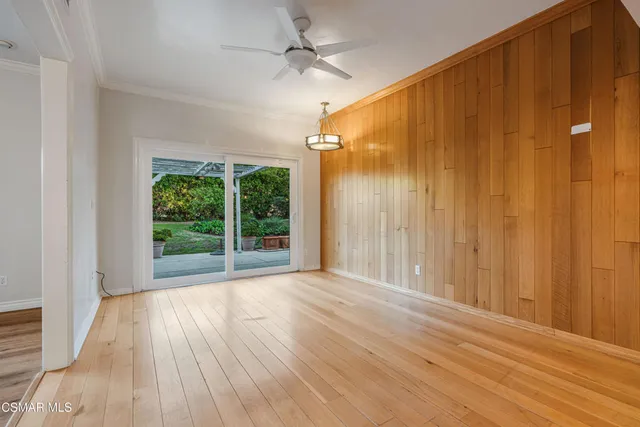 a view of a room with wooden floor and fan