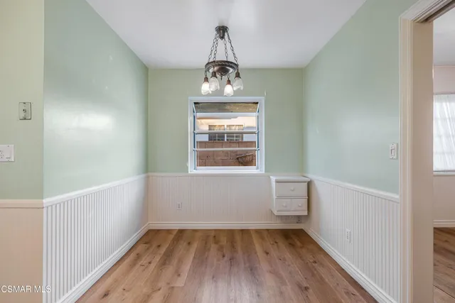 a view of a hallway view with wooden floor and staircase