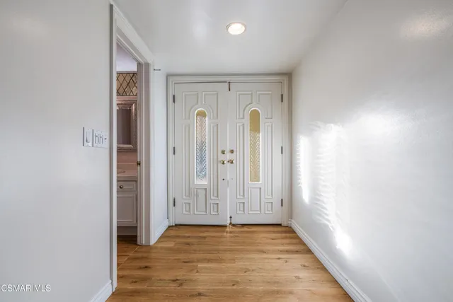 an empty room with wooden floor and sliding door