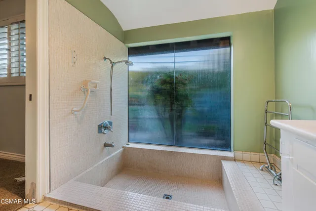 a bathroom with a bathtub and a shower