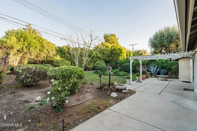 a view of backyard with plants and outdoor seating