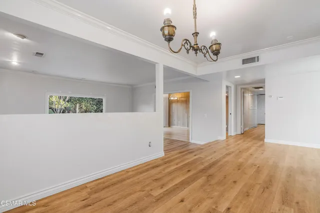 a view of an empty room with a chandelier