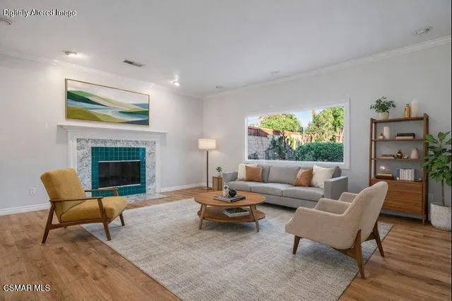 a living room with furniture a fireplace and a large window