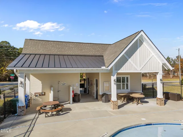 a view of a patio with table and chairs under an umbrella with wooden floor