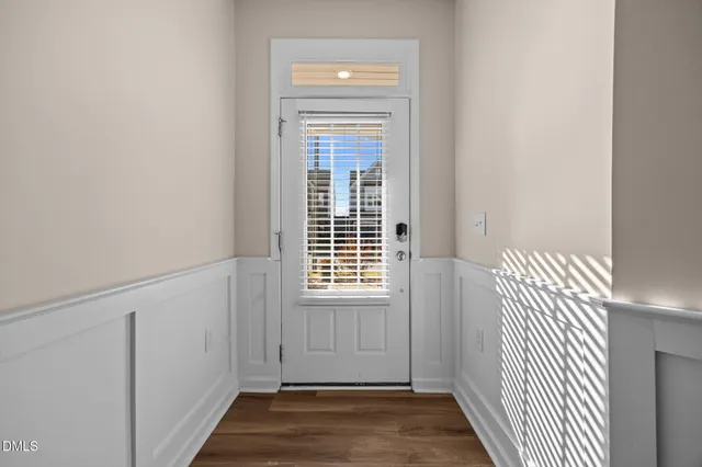 a view of an entryway with wooden floor