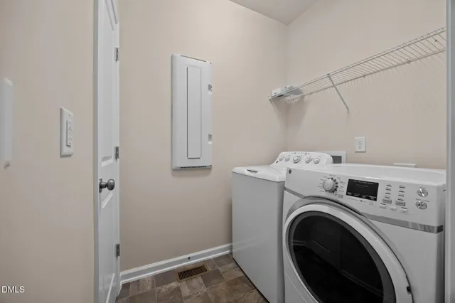 a view of storage and utility room with washer and dryer