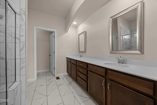 a bathroom with a double vanity sink and mirror