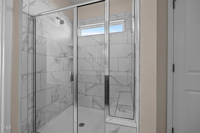 a bathroom with a glass shower door