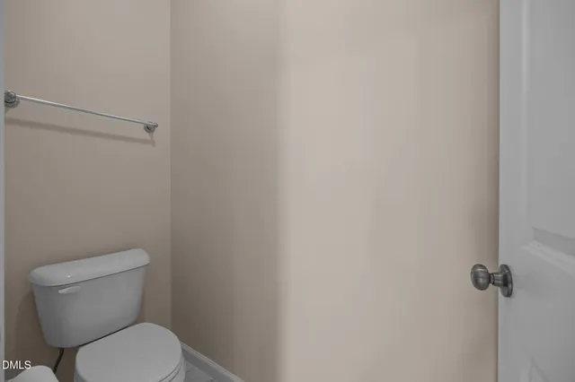 a white toilet sitting next to a shower
