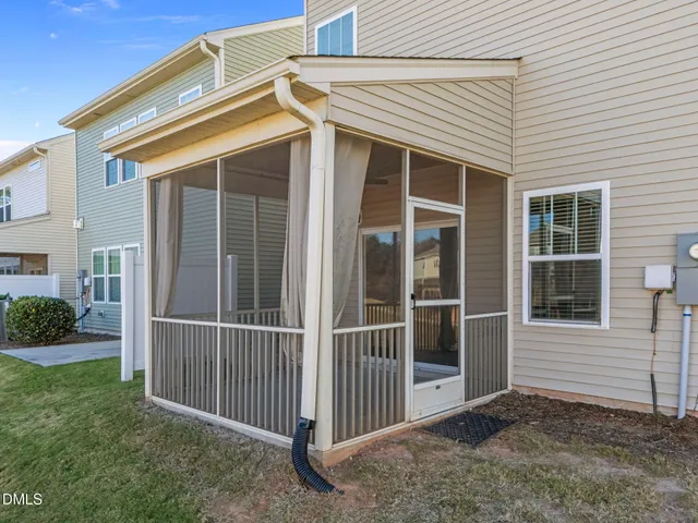a view of a house with a large window and yard