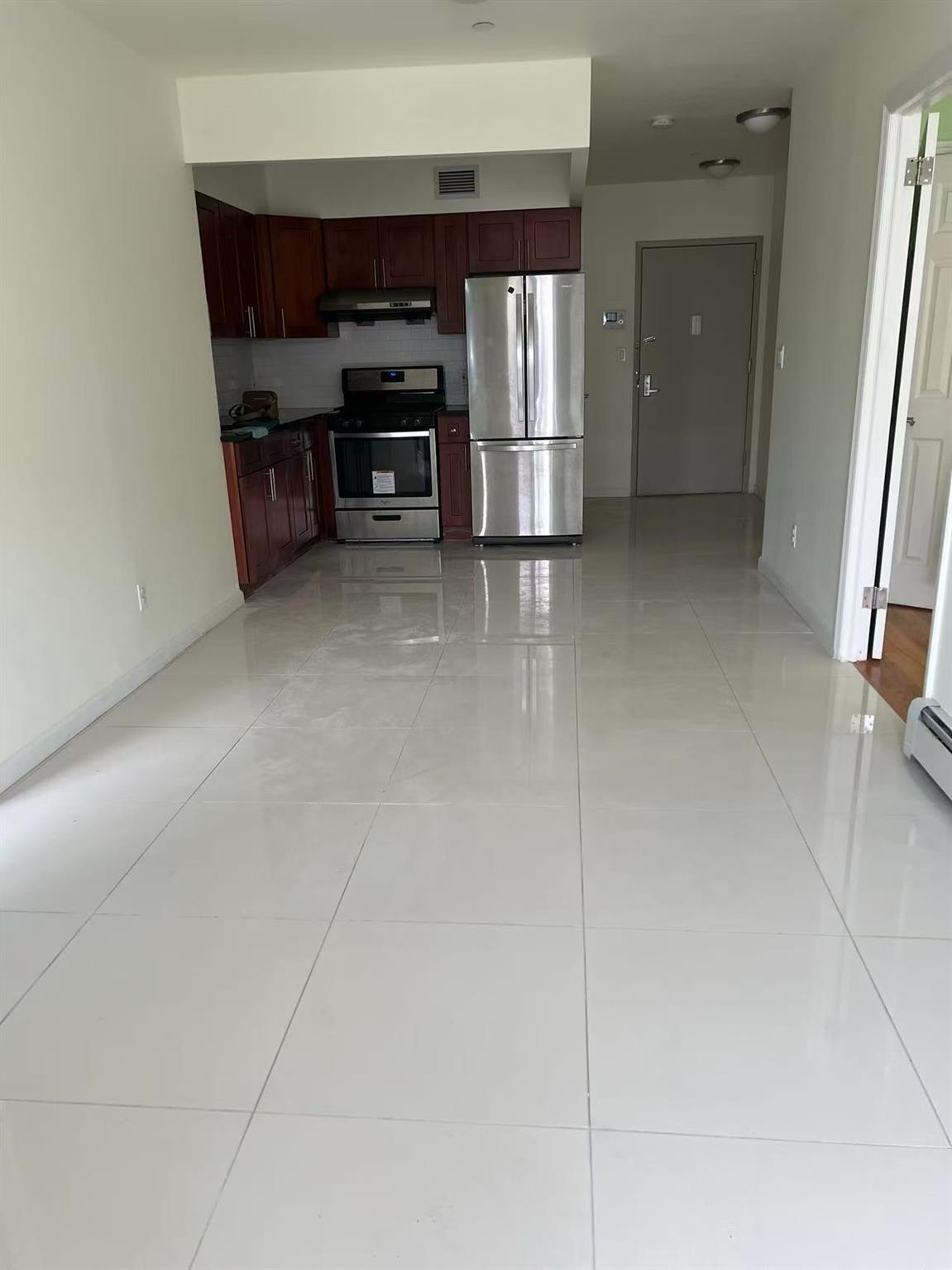 31-53 Linden Place, Unit 2E Queens, NY 11354 - Photo 2 of 7 a view of kitchen and front door