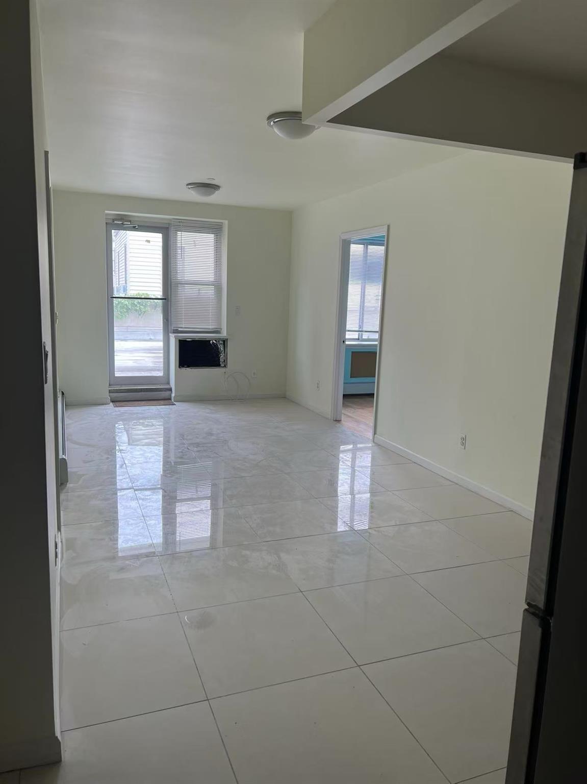 31-53 Linden Place, Unit 2E Queens, NY 11354 - Photo 3 of 7 a view of an empty room and window