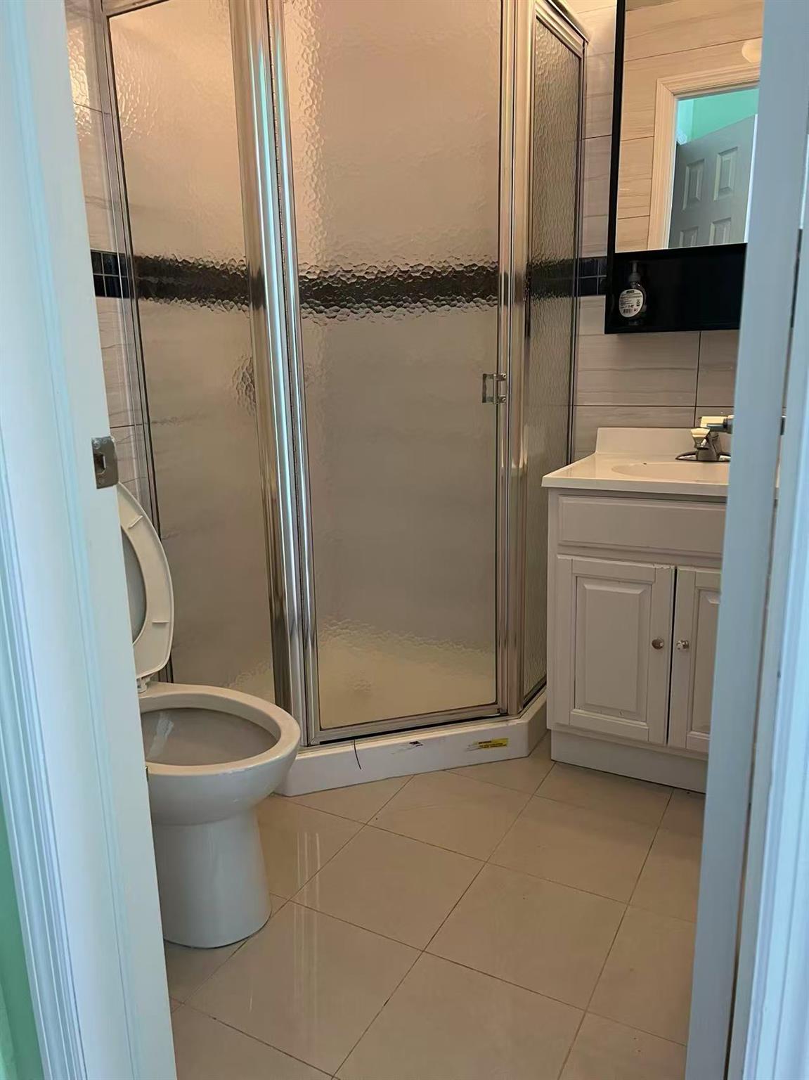 31-53 Linden Place, Unit 2E Queens, NY 11354 - Photo 6 of 7 a bathroom with a granite countertop toilet and a sink