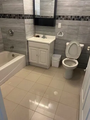 a bathroom with a sink a toilet and bathtub