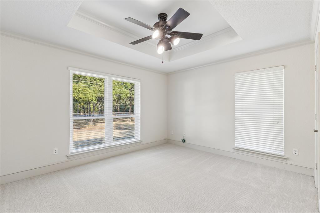 1155 Point Vista Road Hickory Creek, TX 75065 - Photo 31 of 40 Recessed ceiling with a contemporary ceiling fan, white walls, and light-toned carpeting