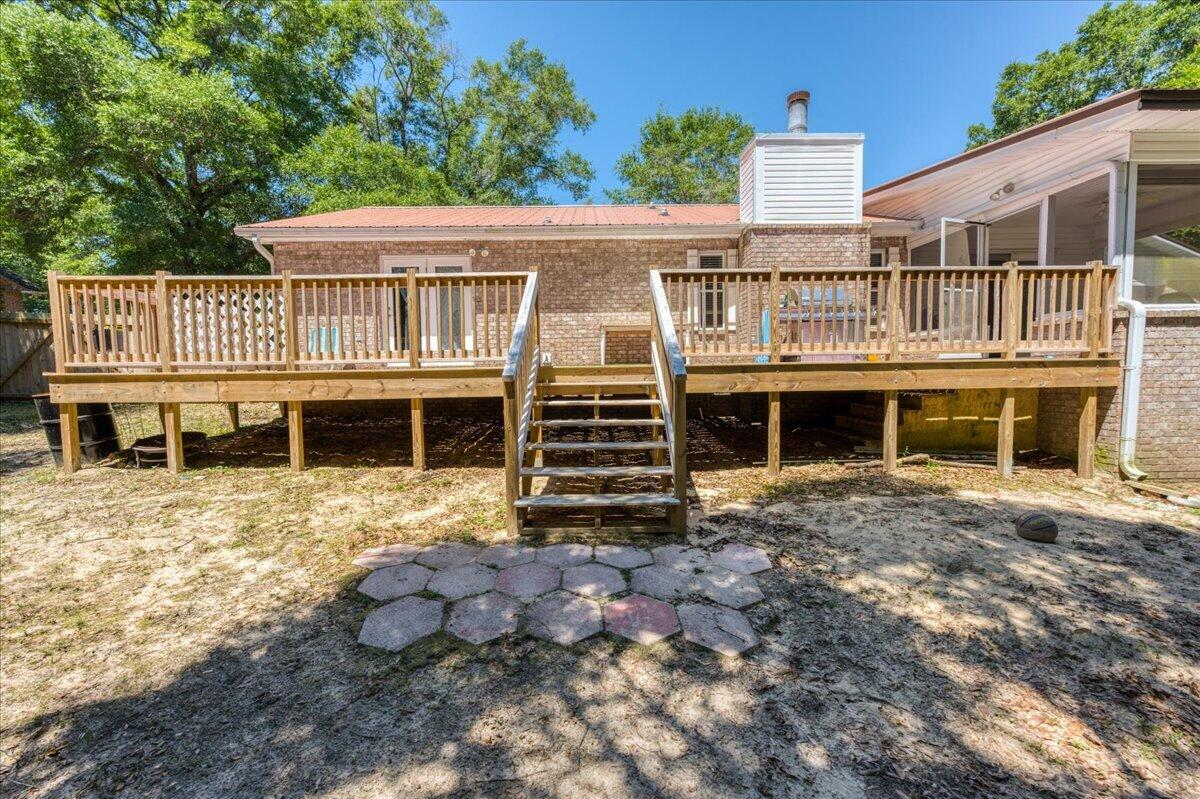 210 Shell Drive Crestview, FL 32536 - Photo 55 of 67 a view of a house with a yard and deck