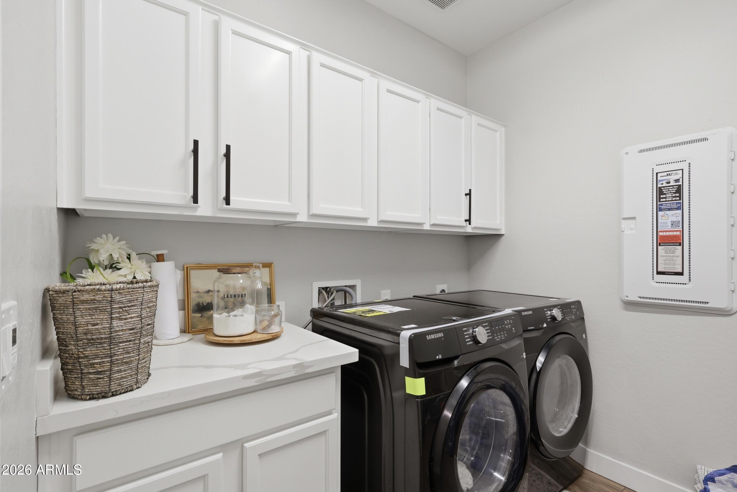 12517 West Lawrence Road Glendale, AZ 85307 - Photo 13 of 52 a view of cabinets a washer and dryer