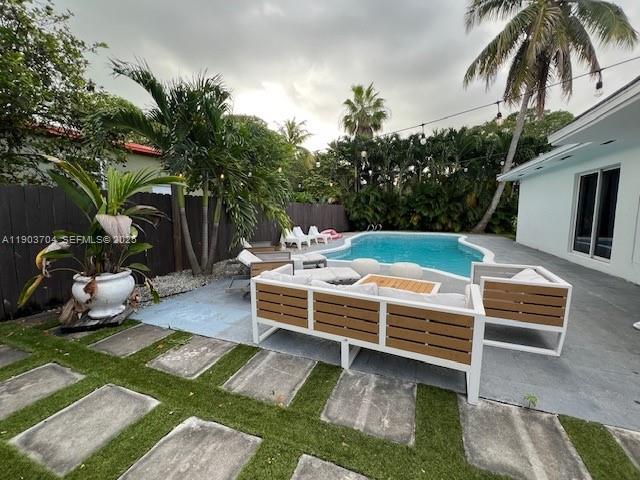 201 Northeast 48th Street Miami, FL 33137 - Photo 13 of 19 a view of a backyard with chairs potted plants and a large tree
