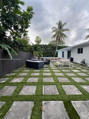 a front view of a house with a yard patio and fire pit