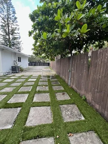 a view of a backyard with swimming pool