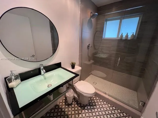 a bathroom with a toilet a sink and shower