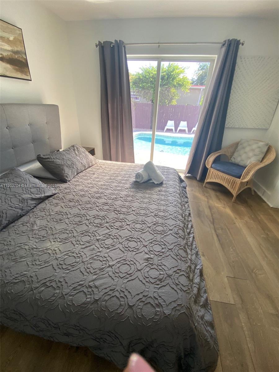 201 Northeast 48th Street Miami, FL 33137 - Photo 6 of 19 a bed sitting in a bedroom next to a window