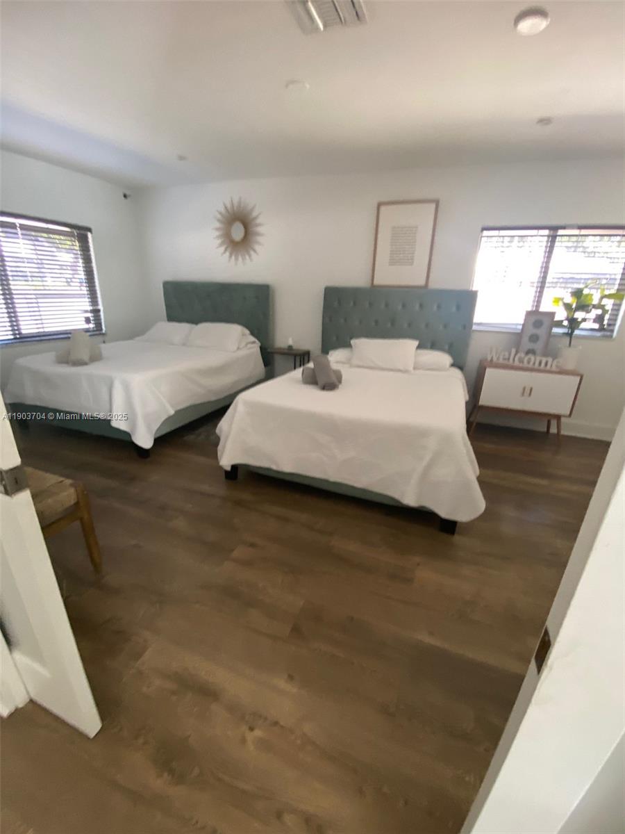 201 Northeast 48th Street Miami, FL 33137 - Photo 9 of 19 a bedroom with two beds and a large mirror