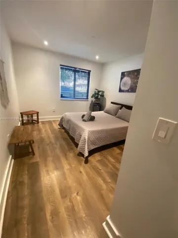 a bedroom with a bed and a night stand