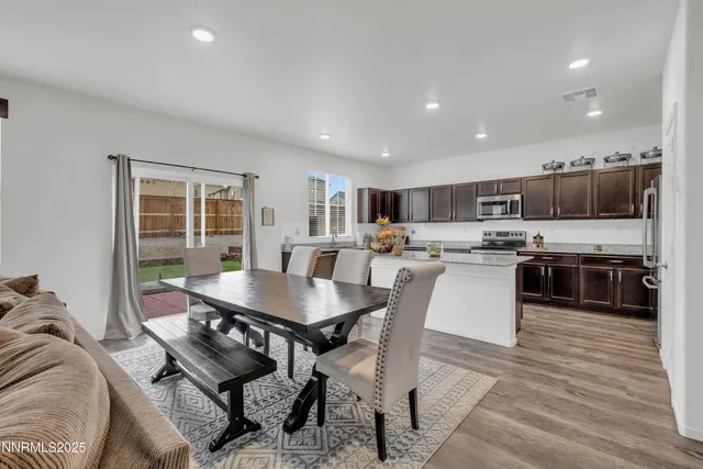 a view of a dining room with furniture and wooden floor
