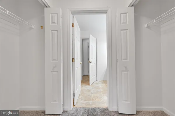 a bathroom with double vanity sink a vanity and a large mirror