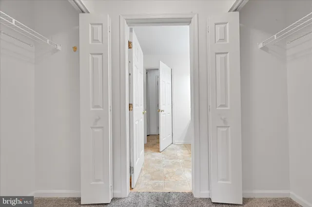 a bathroom with double vanity sink a vanity and a large mirror