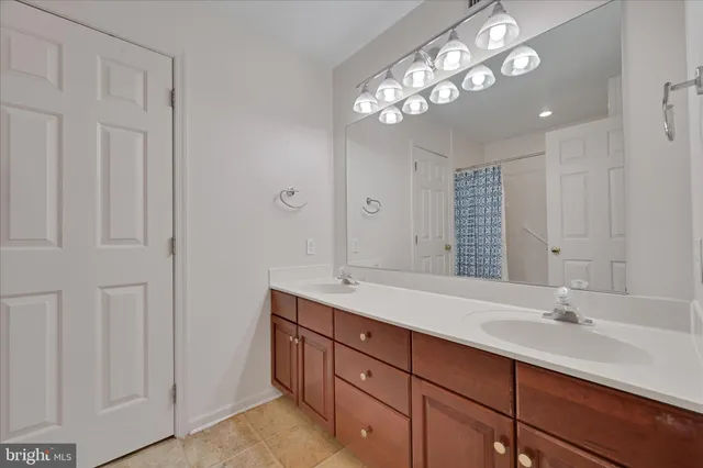 a bathroom with a double vanity sink and a toilet