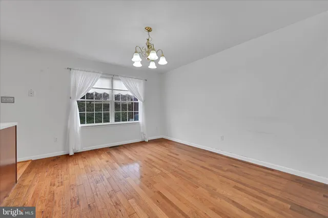 a view of livingroom with wooden floor and chandelier