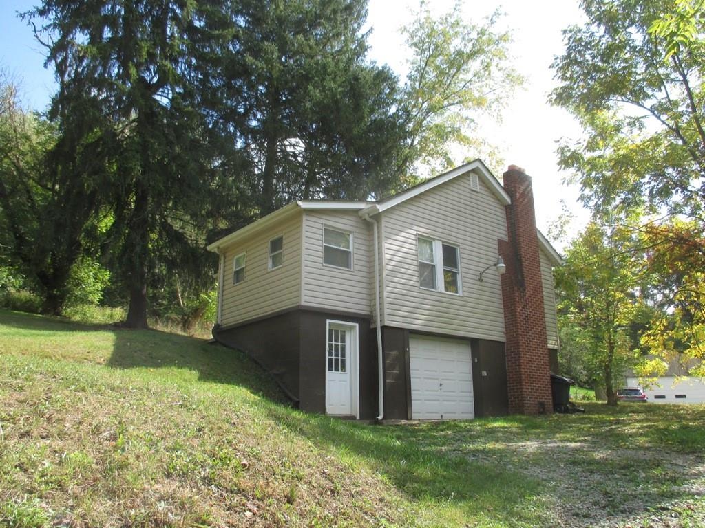 94 McCarrell Road Hickory, PA 15340 - Photo 4 of 22 a front view of a house with a yard and trees