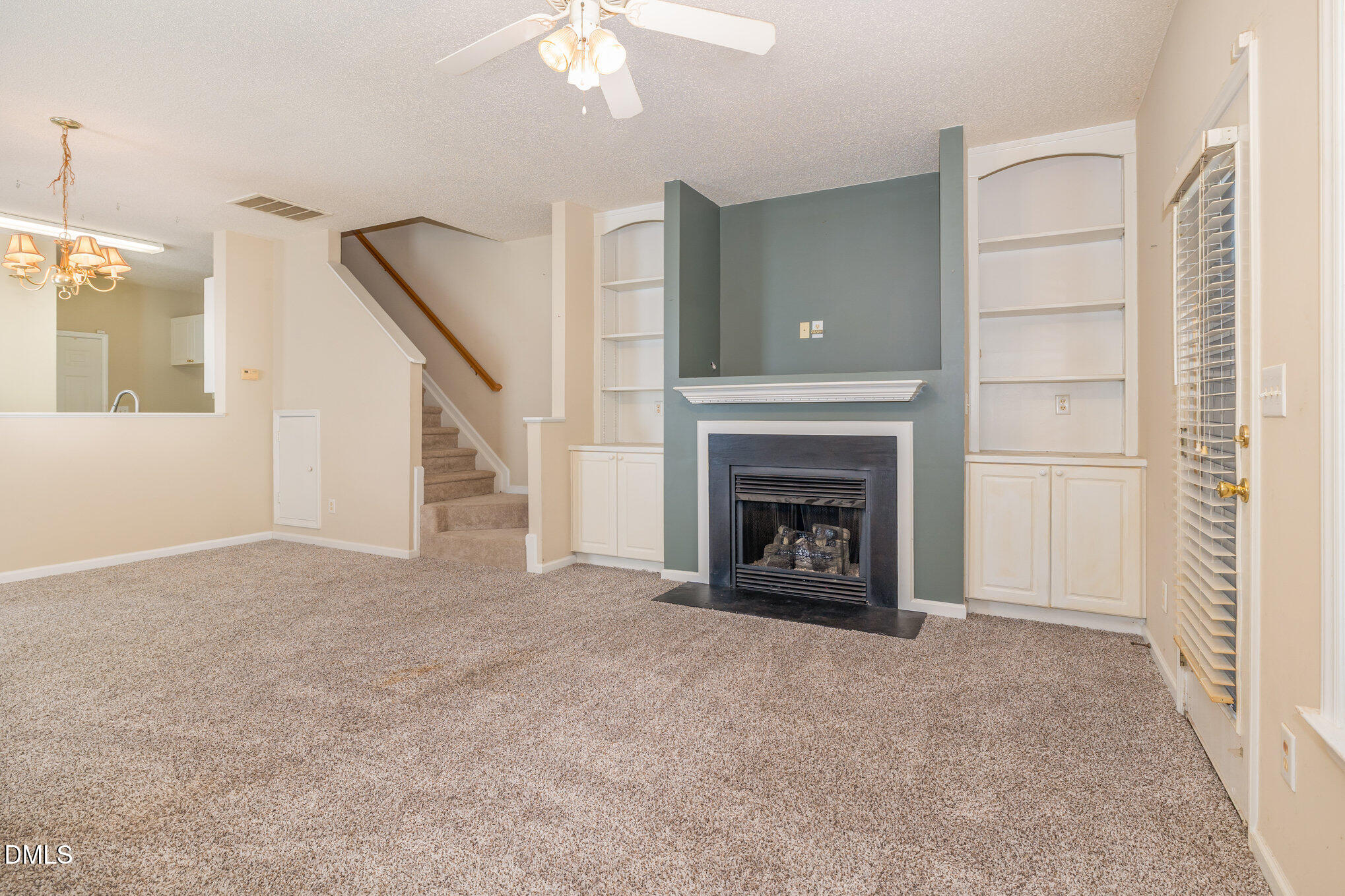 2116 Metacomet Way Raleigh, NC 27604 - Photo 5 of 24 a view of an empty room with a fireplace and a window