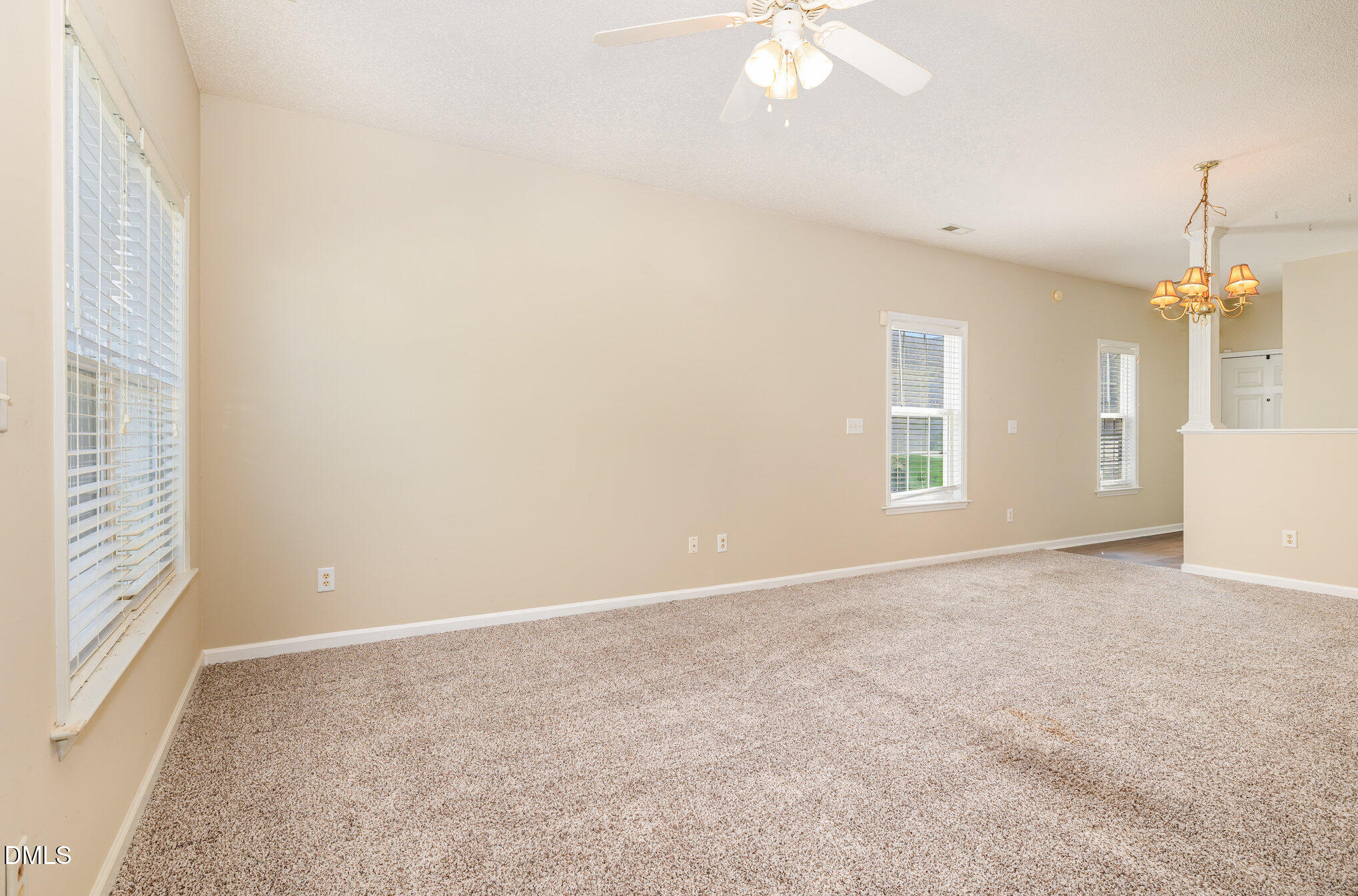2116 Metacomet Way Raleigh, NC 27604 - Photo 7 of 24 an empty room with windows and ceiling fan