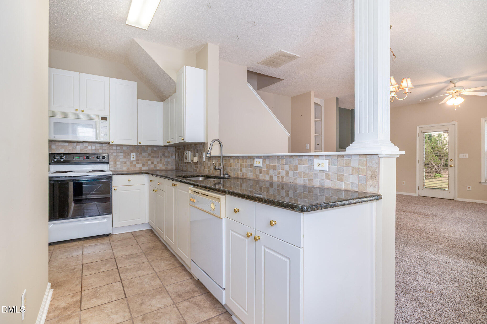 2116 Metacomet Way Raleigh, NC 27604 - Photo 8 of 24 a kitchen with granite countertop a sink and cabinets