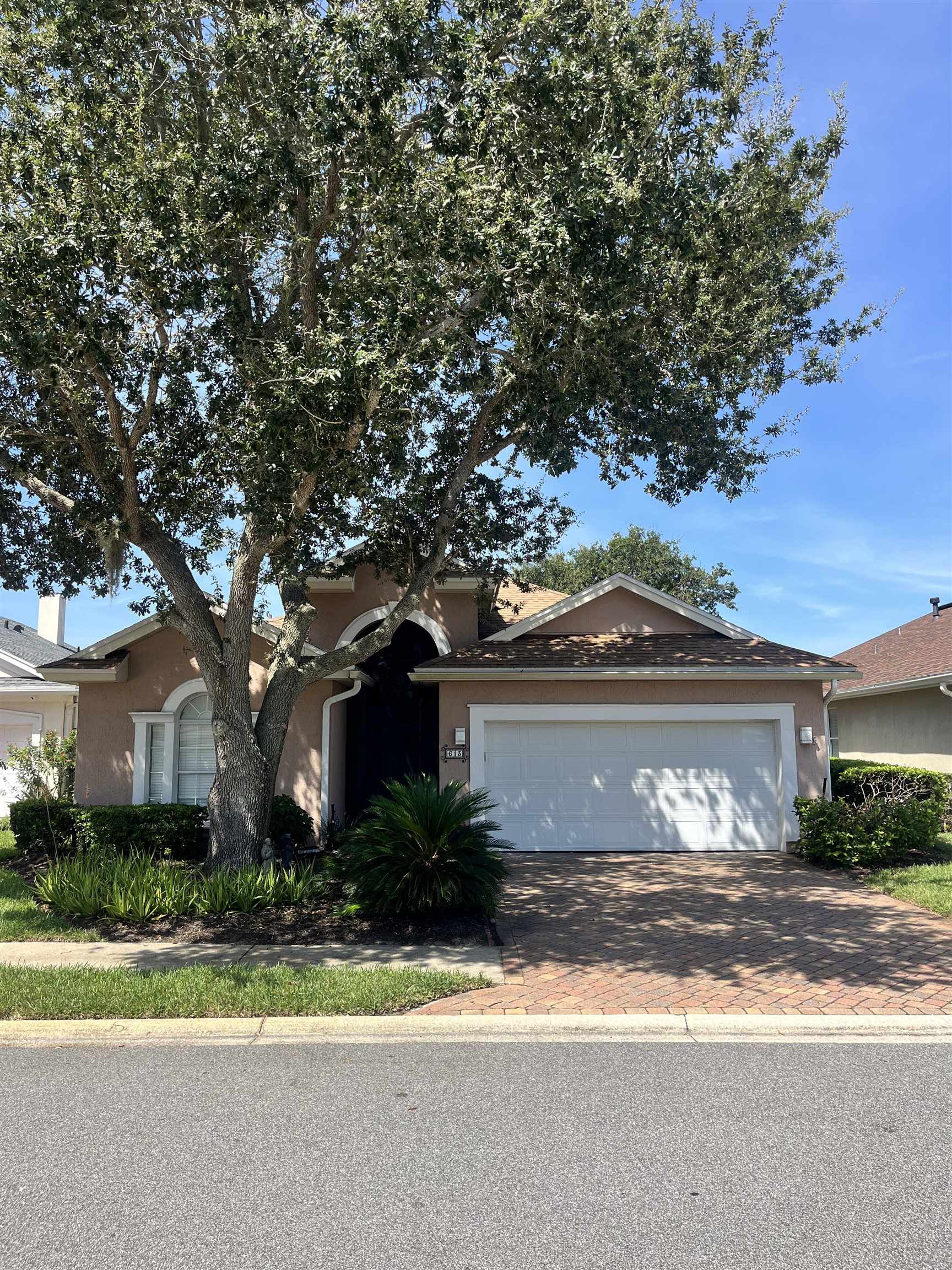 a front view of a house with a yard and a garage