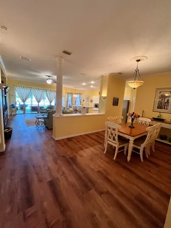 a view of a dining room with furniture wooden floor and chandelier