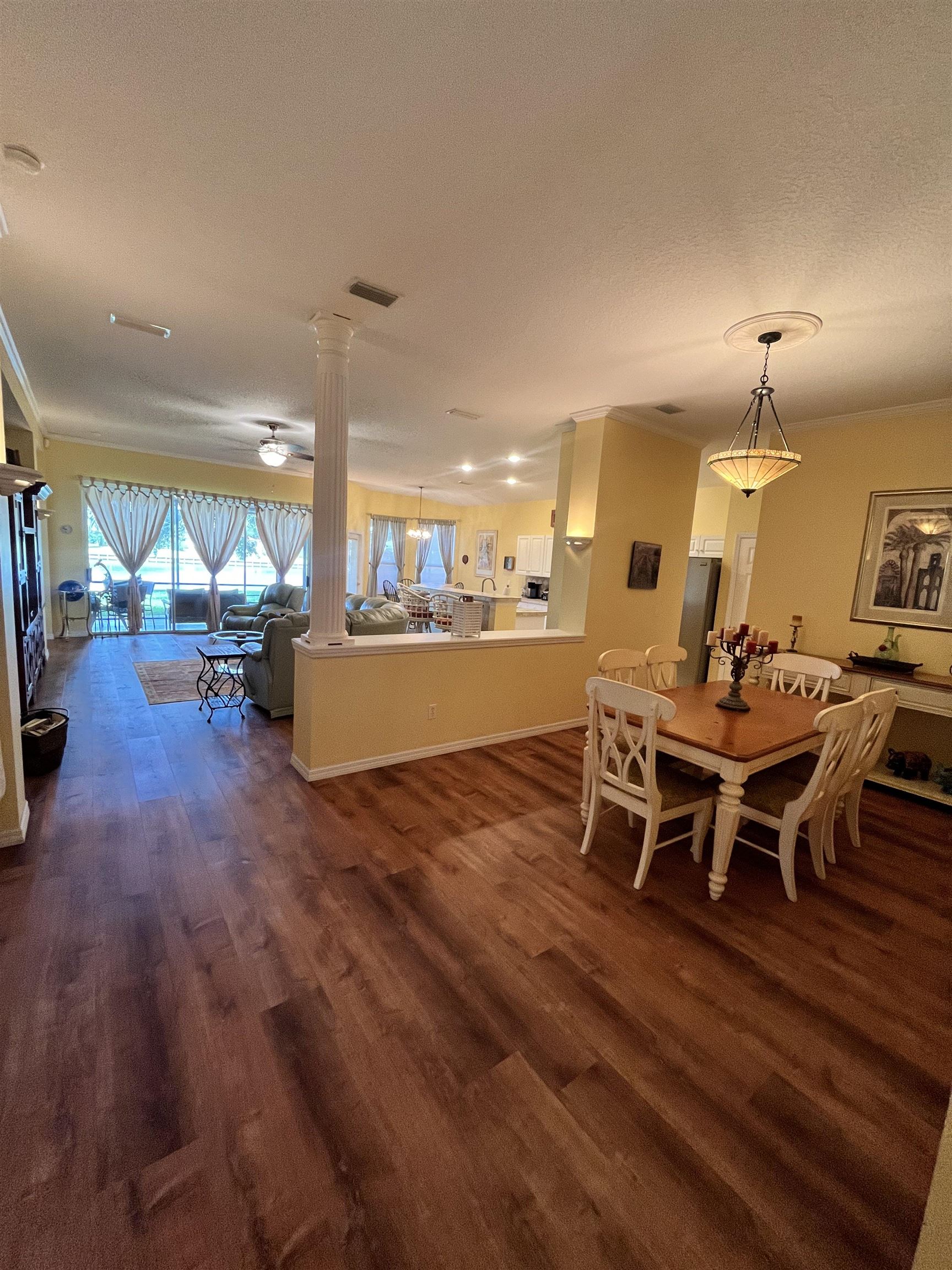 613 Casa Fuerta Lane St. Augustine, FL 32080 - Photo 2 of 23 a view of a dining room with furniture wooden floor and chandelier
