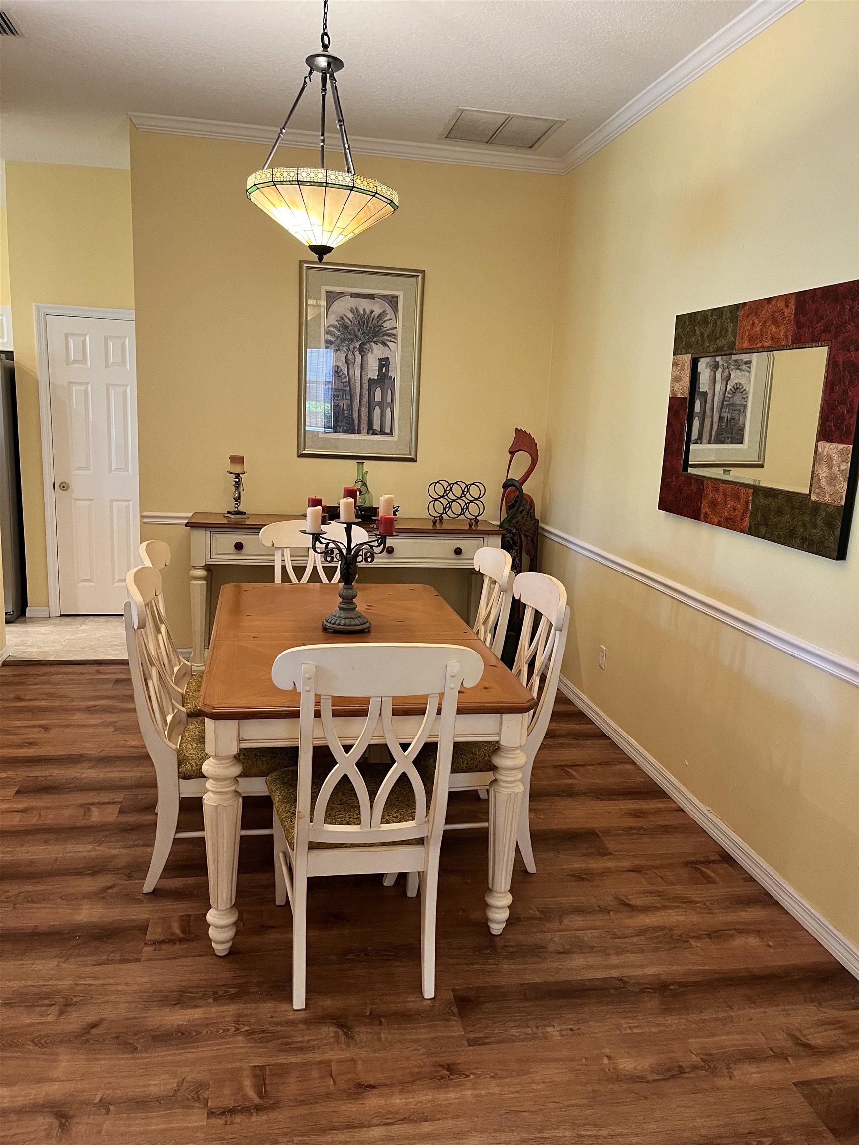 613 Casa Fuerta Lane St. Augustine, FL 32080 - Photo 3 of 23 a dining room with furniture a chandelier and wooden floor